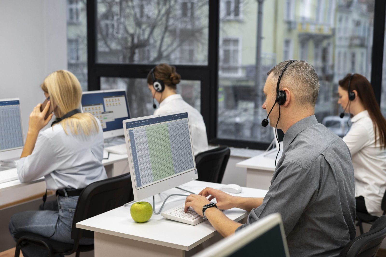 colleagues-working-together-call-center-with-headphones (1) (1)